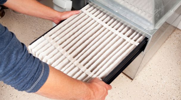 person inspecting an air filter